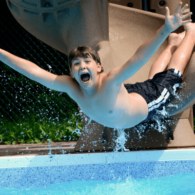 Boy with ADHD sliding into the pool