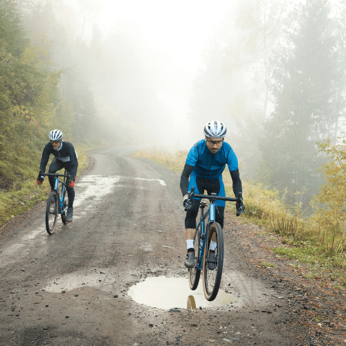 two cyclists on a gravel trail