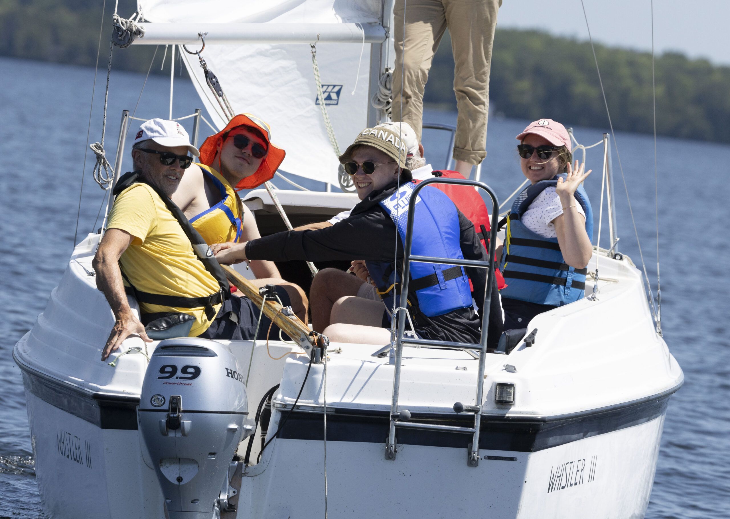 counselors and campers sitting by their cabin